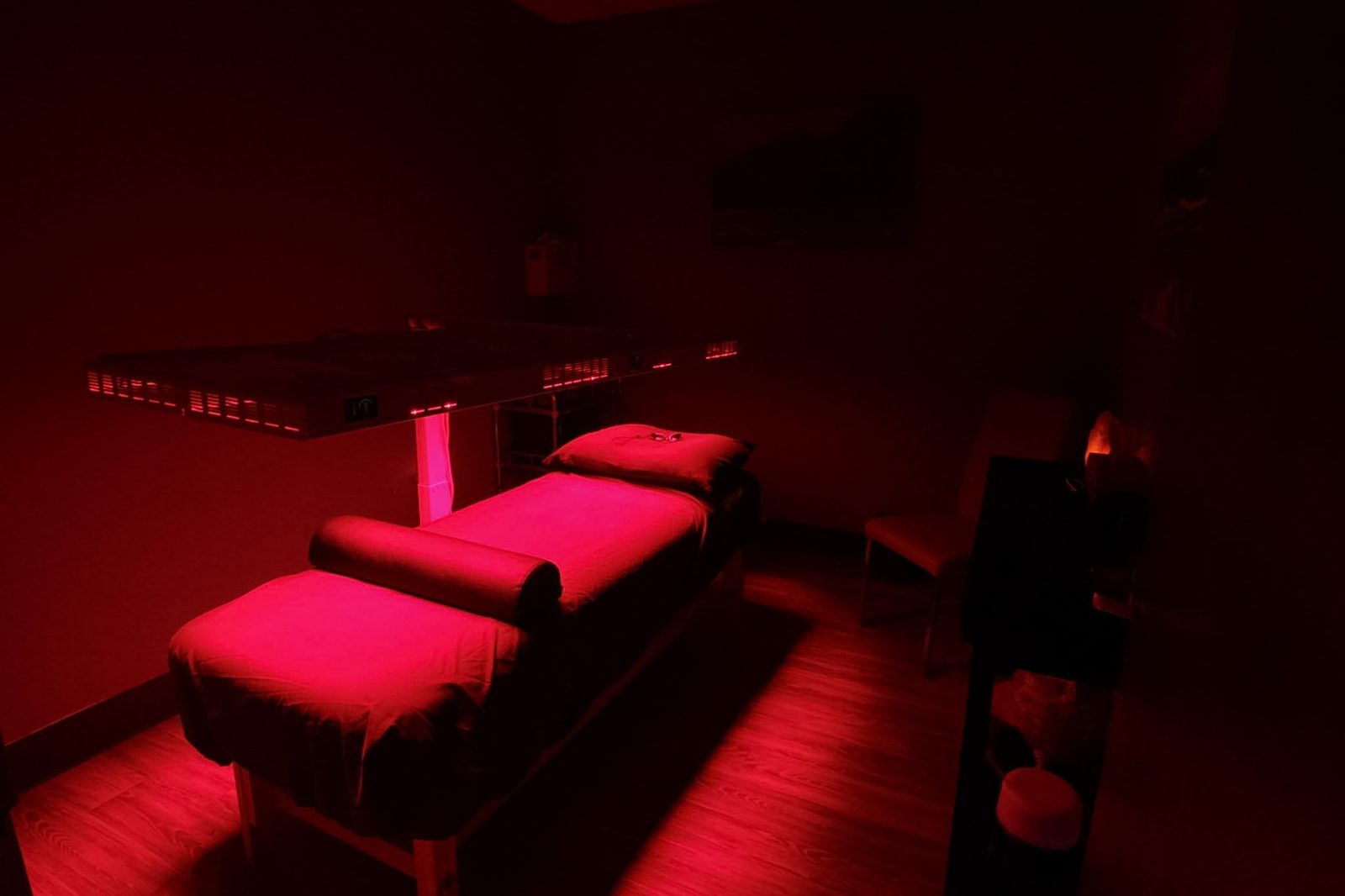 Red light therapy room with the full-body LED panel illuminated