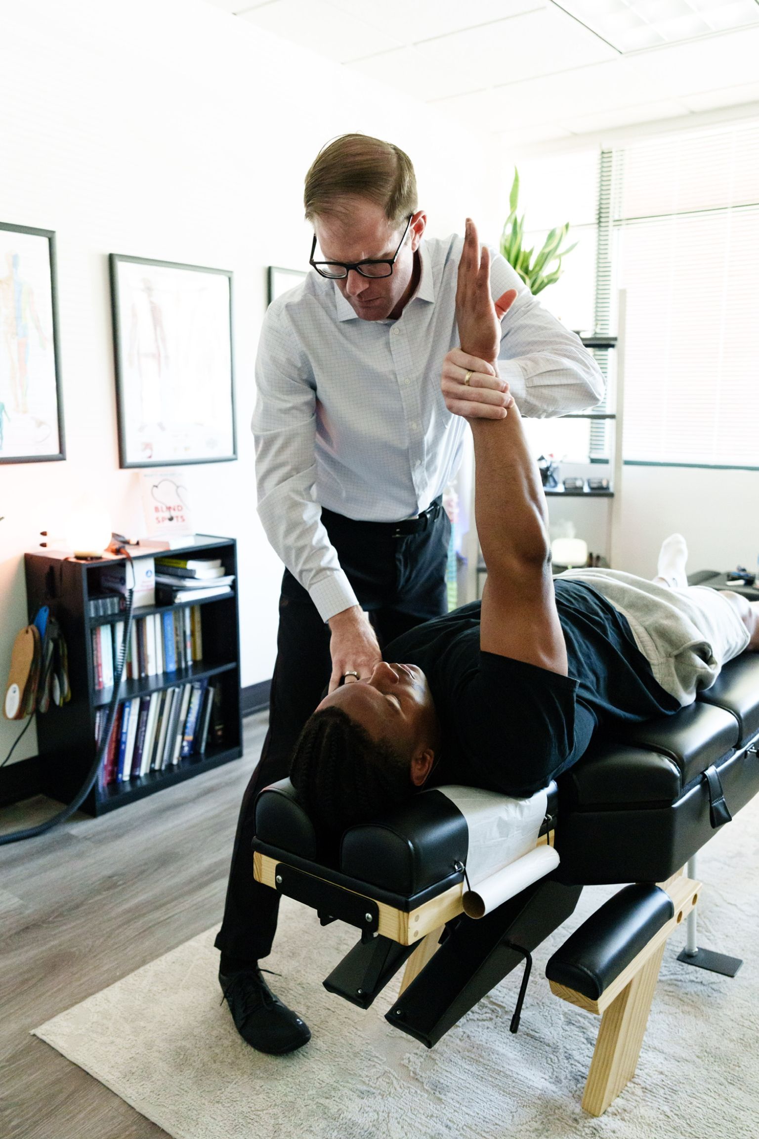 Dr. Sean Olenek adjusting an athlete
